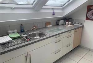 a kitchen counter with a sink and a window at Gemütliche 3 Zimmerwohnung in Ühlingen-Birkendorf +7 photos