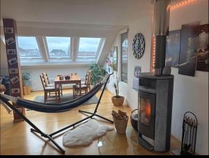 a living room with a hammock and a fireplace at Gemütliche 3 Zimmerwohnung in Ühlingen-Birkendorf