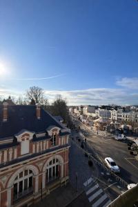 a view of a city with a building and a street at Hôtel Belle Fontainebleau in Fontainebleau