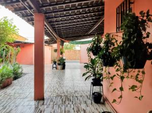 an empty courtyard with potted plants in a building at Rosa cheirosa in Barreirinhas