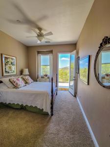 a bedroom with a bed and a ceiling fan at Beverlys Hilltop Retreat in Fallbrook
