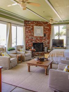 a living room with a bed and a fireplace at Beverlys Hilltop Retreat in Fallbrook