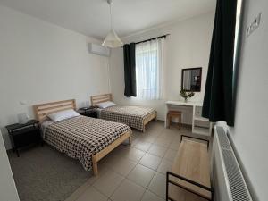 a bedroom with two beds and a table and a mirror at Horizon in Kythira