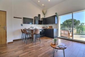 a kitchen with a table and chairs in a room at Les Restanques in Trets