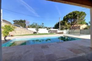 a swimming pool in the backyard of a house at Les Restanques in Trets