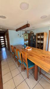 a kitchen with a long wooden table and chairs at Hostal Celta in Pucón