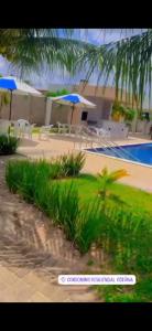 a view of a resort with a pool and umbrellas at aconchegante e tranquila in Parnamirim