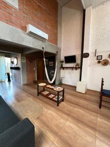 a living room with a couch and a hammock at Casa Estilo Industrial in Encarnación