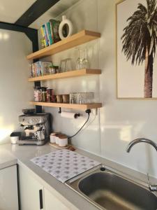 a kitchen with a sink and a counter top at Cabin on the Creek in Boyne Island