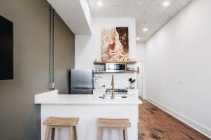 a kitchen with a counter and two stools at The Harriss in Wilson