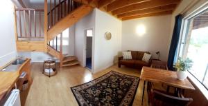 a living room with a staircase and a table at Denmark Waterfront Lodge in Denmark