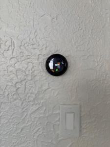a circular object on a white wall with a lightswitch at Pittsburgh Getaway - Private Home- 2 Beds in Pittsburgh