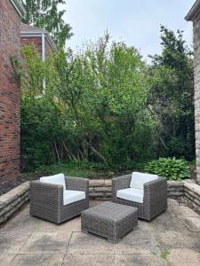 two wicker chairs and a table on a patio at Pittsburgh Getaway - Private Home- 2 Beds in Pittsburgh