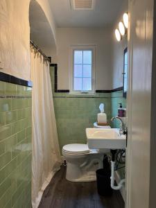 a bathroom with a toilet and a sink at Pittsburgh Getaway - Private Home- 2 Beds in Pittsburgh +9 photos