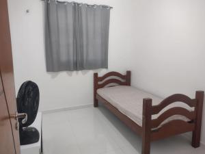 a small bedroom with a bed and a fan at AZURE residence in Caucaia +11 photos