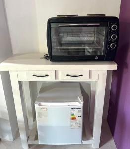 a white table with a microwave on top of it at Monoambiente Noah in Ezeiza