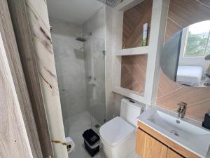 a small bathroom with a toilet and a sink at Confortable apto en Armenia 1505 in Armenia +12 photos
