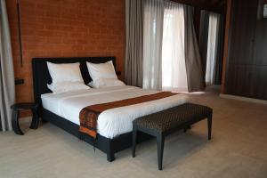 a bedroom with a bed and a chair and a window at Aerys Village in Somone +34 photos