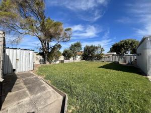 a backyard with a fence and a grass yard at Southern Comfort in Esperance in Esperance