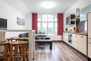 a kitchen and dining room with a table and chairs at Ferienwohnungen Ammerwinkel in Oberammergau