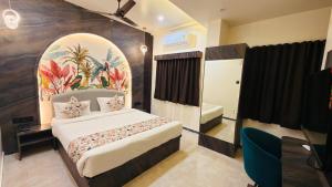 a bedroom with a large bed in a room at Hotel Radhe in Junagadh