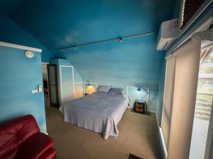 a blue bedroom with a bed and a blue ceiling at Blue Monkey Mountains in Newnes Junction
