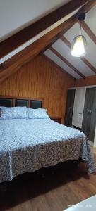 a bedroom with a bed with a blue comforter at casona amplia y comoda in La Serena