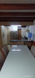 a kitchen with a large white table in a room at casona amplia y comoda in La Serena