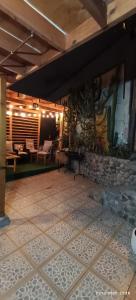 a patio with a table and a stone wall at casona amplia y comoda in La Serena