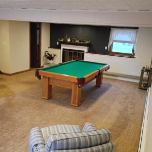 a living room with a pool table and a couch at Cliffside Cottage in Mansfield