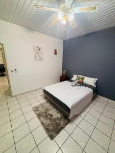 a bedroom with a bed and a ceiling fan at Sermie T4 à kourou avec piscine in Kourou