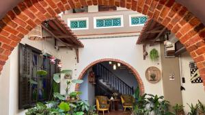an archway in a building with a table and chairs at ke-lan-tan House in George Town