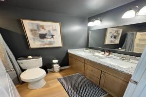 a bathroom with a toilet and a sink and a mirror at The Blue Venue-Periwinkle in Clarksville