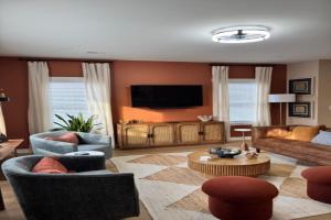 a living room filled with furniture and a flat screen tv at The Blue Venue-Periwinkle in Clarksville