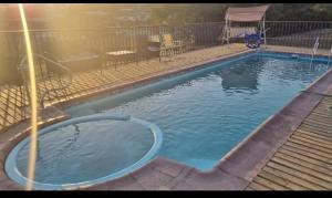 a swimming pool with a hose in the water at Cabaña Quillaycillo in La Rudilla