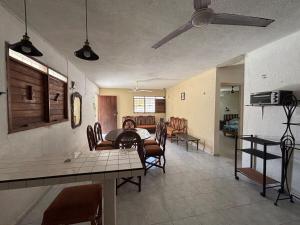 a living room with a table and a dining room at House 30 meters from the sea in Chicxulub