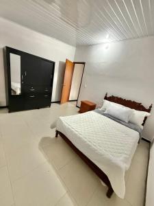 a bedroom with a large bed and a television at Casa Sué Soatá in Soatá