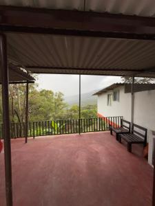 a screened in porch with two benches on a balcony at Casa Sué Soatá in Soatá