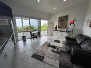 a living room with a couch and a table at Taipa Coastal Retreat in Taipa