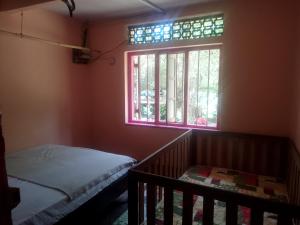 a bedroom with a bed and a window at Sehandi Hotels - Renaissance Ella in Ella