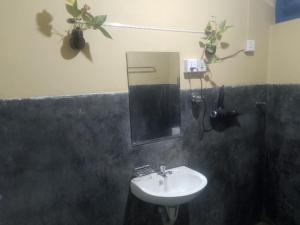 a bathroom with a sink and a mirror at Sehandi Hotels - Renaissance Ella in Ella +3 photos