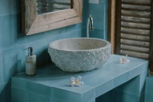 a bathroom with a bowl sink on a blue wall at Green vanilla mincung 1 in Silebeng +26 photos