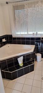 a bath tub in a bathroom with a window at Aeris Holiday Home Flinders NSW Pet Friendly in Croom +11 photos
