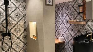 a bathroom with a sink and a tile wall at ke-lan-tan House in George Town +34 photos