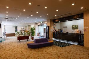 a lobby with a couch and a bar in a building at ホテルグランフォーレ in Shikokuchuo