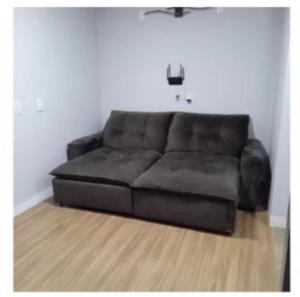 a brown leather couch in a living room at Hotel Mercosul in Butiá
