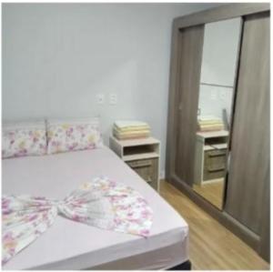 a bedroom with a bed and a large mirror at Hotel Mercosul in Butiá