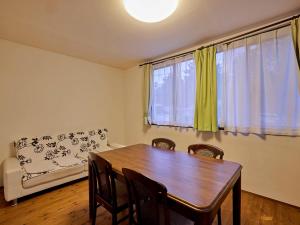 a dining room with a table and chairs and a couch at Casa Allegra in Yamanakako