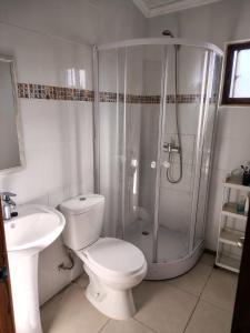 a bathroom with a shower and a toilet and a sink at Maravillas de Tongoy in Tongoy