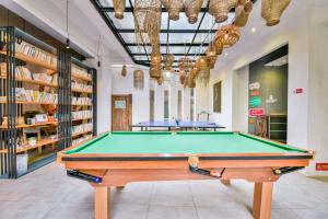 a pool table in the middle of a room at Morning Sun Hotel in Yangshuo